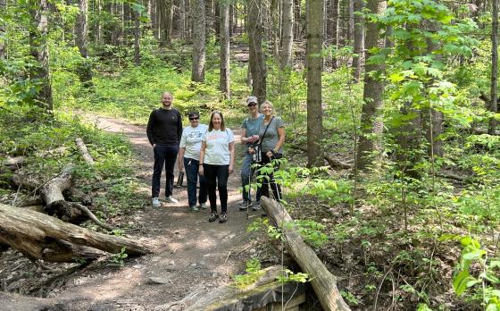 a group of active older adults and a staff member on a hike
