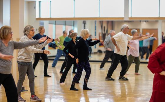 a group of active older adults in a tai chi class at the eastside family ymca