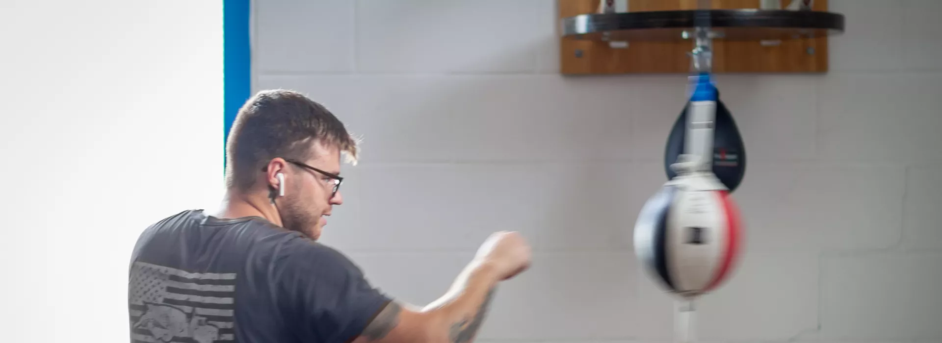 a man boxing with boxing equipment at the corning family ymca